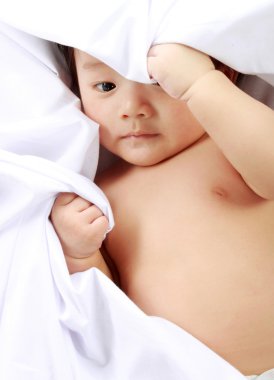 Baby laying on the bed. clipart