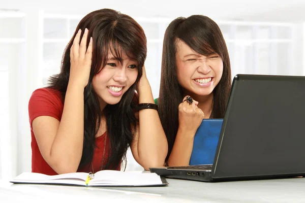 Disappointed student girl on laptop Stock Photo