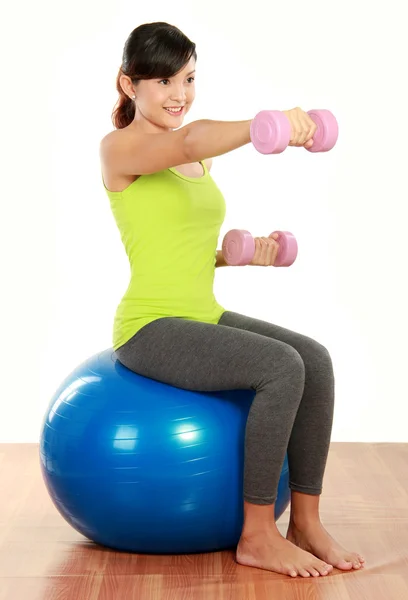 Exercising with dumbbells and pilates ball — Stock Photo, Image