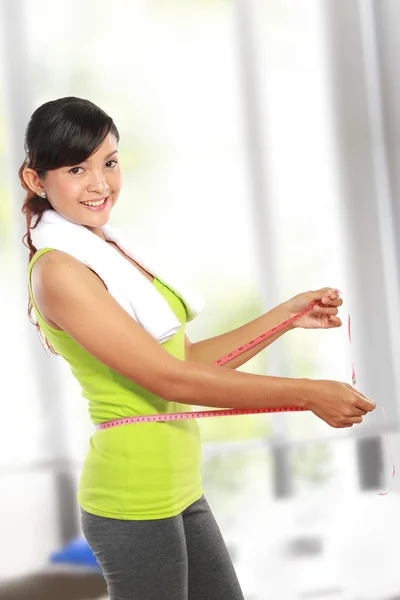 Close up of slim female body with measure tape around her body — Stock Photo, Image