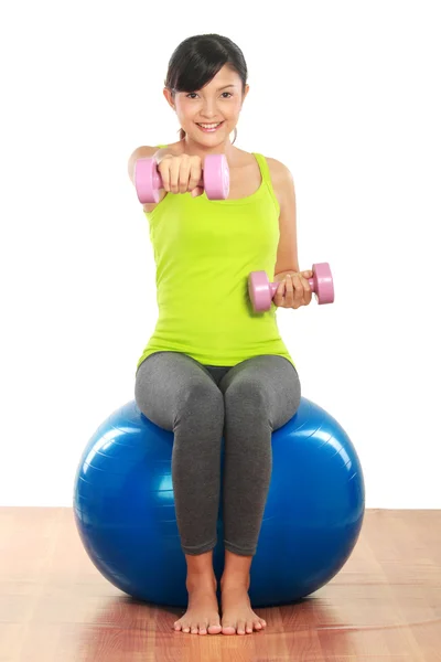 Exercising with dumbbells and pilates ball — Stock Photo, Image