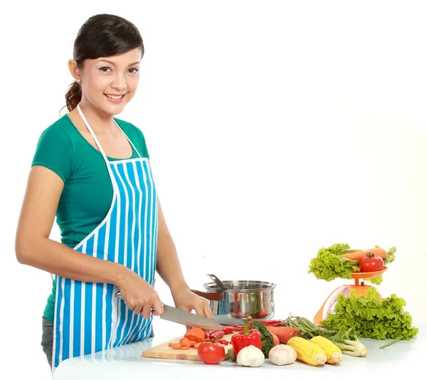 Beautiful woman cutting vegetables — Stock Photo, Image