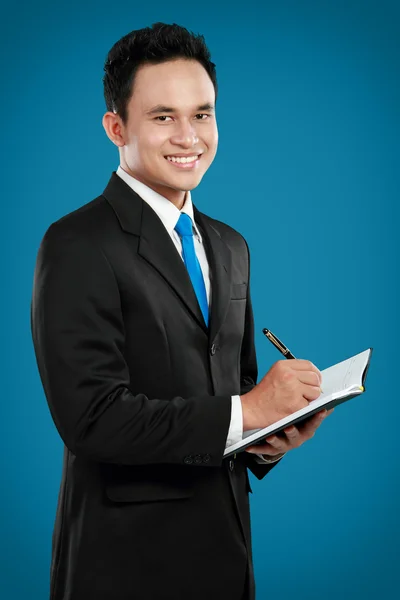 Young business man writing — Stock Photo, Image