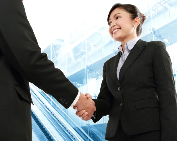 Hand shake between a businessman and a businesswoman Royalty Free Stock Images