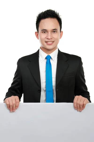 Business man holding a blank billboard — Stock Photo, Image