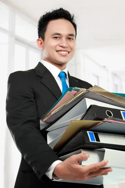 Business man holding stack of files and folders — Stock Photo, Image