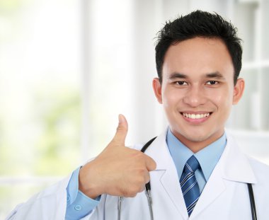 Asian doctor showing okay gesture clipart