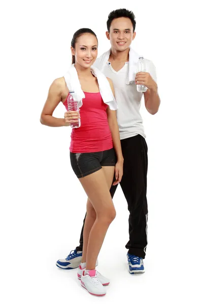 Man and woman with water after workout — Stock Photo, Image
