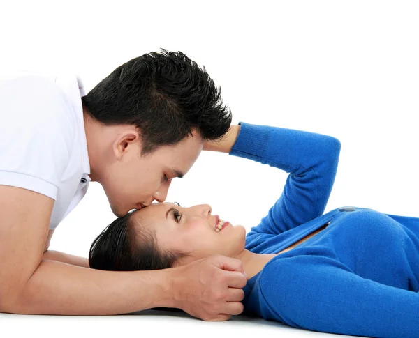 Couple kissing while lying on the floor — Stock Photo, Image