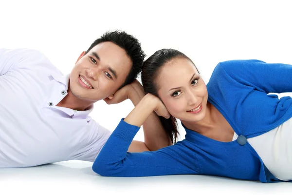 Couple lying on the floor looking at camera — Stock Photo, Image