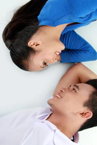 Couple lying on the floor, happy smile looking to each other — Stock Photo, Image