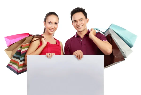 Shopping couple with blank board — Stock Photo, Image