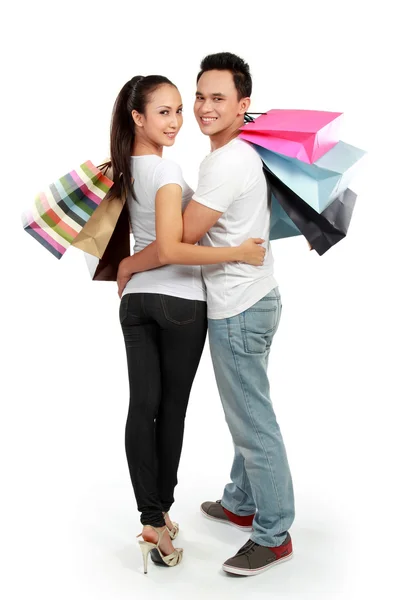 Atractiva pareja feliz llevando bolsa de compras —  Fotos de Stock