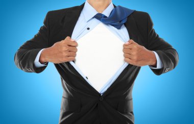 Businessman showing a superhero suit