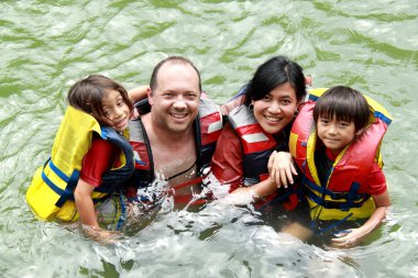 Family in the water clipart