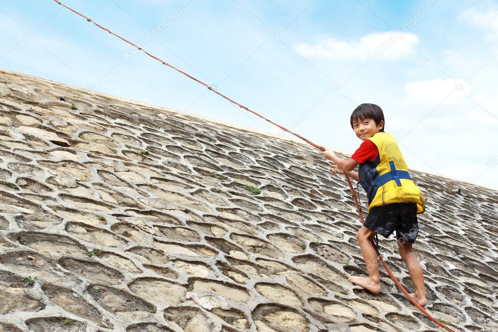 Kid climbing using rope