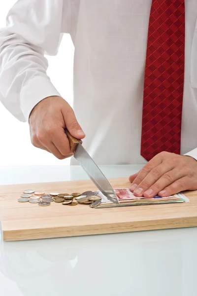 Empresario cortando la moneda — Foto de Stock