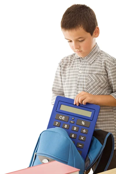 Schoolboy putting a calculator in the schoolbag Stock Photo