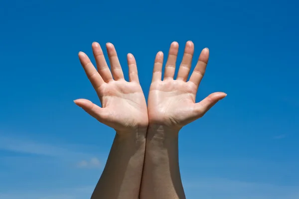 stock image Hands against blue sky