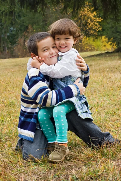 Happy children embracing to each other — Stock Photo, Image