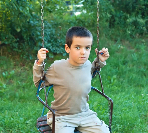 Boy swinging — Stock Photo, Image