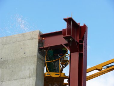 Welders on a construction site clipart