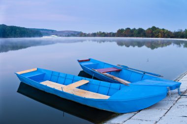 Two blue boats on lake clipart