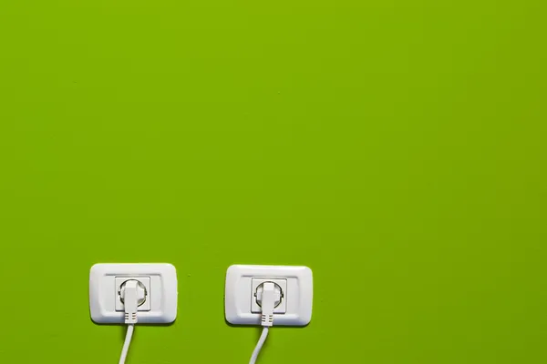 Elektrické zásuvky na zelené zdi — Stock fotografie