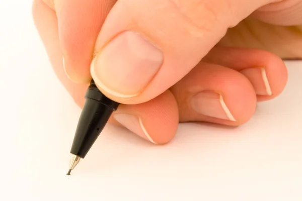 Черный карандаш в руке Лицензионные Стоковые Изображения