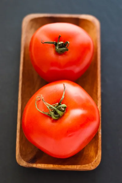 Two tomatoes in tray — Stock Photo, Image