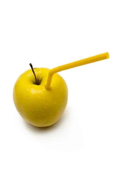 Gele appel met stro Stockafbeelding