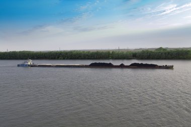 Coal of barge on river Mississippi clipart