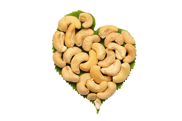 Ripe cashew nuts with leaves on a white background — Stock Photo, Image