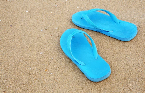 stock image Blue slippers on the beach