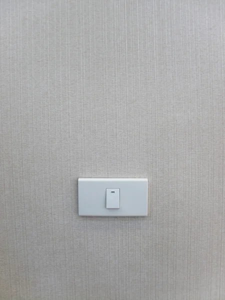 Biały wyłącznik na tle ściany — Zdjęcie stockowe