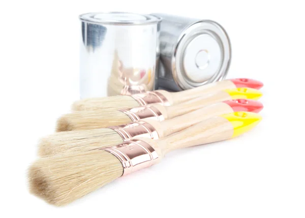 Cans of paint with paintbrushes isolated on white — Stock Photo, Image