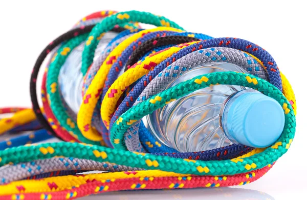 Colorful strings and bottle of water — Stock Photo, Image
