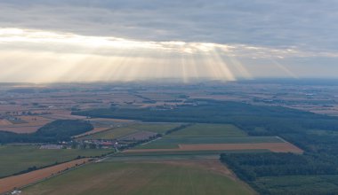 Light rays shine through the dark clouds clipart