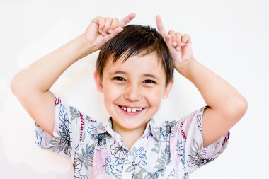 Boy shows horns clipart