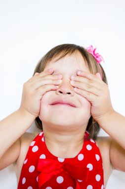 The little girl covered her eyes with her hands clipart