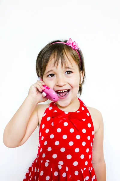 Lille pige taler i telefon - Stock-foto