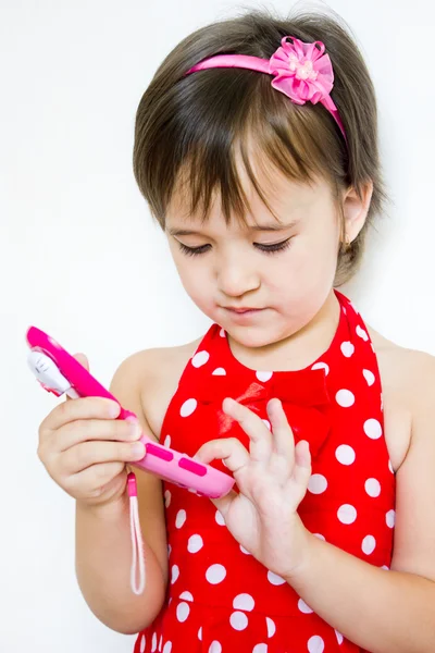 Little girl on the phone dials the number — Stock Photo, Image