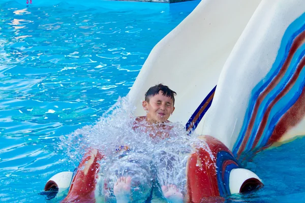 Little boy on a water slide — Stock Photo, Image