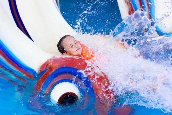 Little girl on a water slide Stock Image