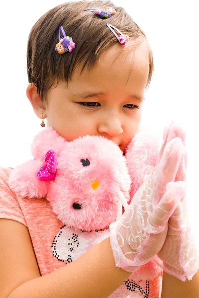 A little girl in a pink dress claps — Stock Photo, Image