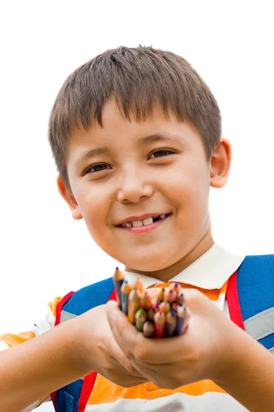 Skolpojke med färgpennor i händerna — Stockfoto