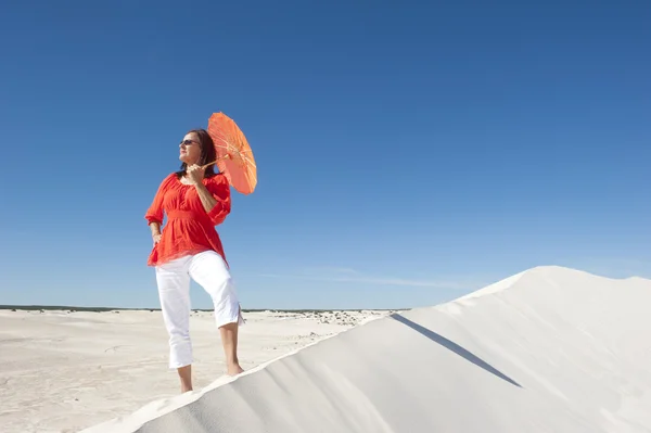 Уверенная женщина на песчаной дюне пустыни — стоковое фото