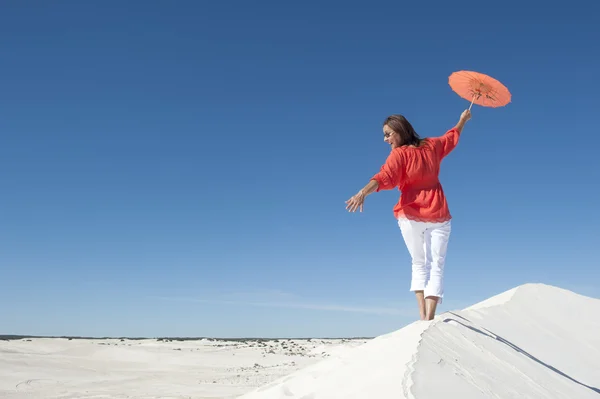 Beautiful mature woman balancing on sand dune — Stock Photo, Image