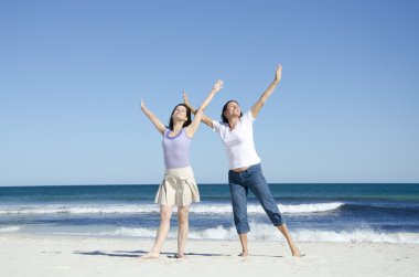 Two cheerful happy women at the beach clipart