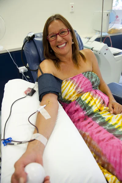 Blood donation by happy woman — Stok fotoğraf